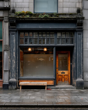 British high street shopfront with painted wood panels and large blank window