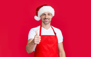 happy mature man in red barista apron and christmas santa hat