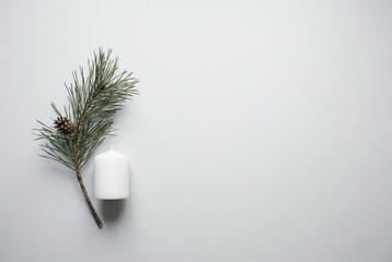 Minimal tabletop with pine twig and white candle