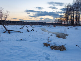 Snowy landscape with a river running through it