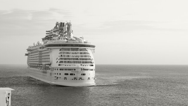 Royal Caribbean cruise ship sailing on calm waters during sunset toned in Colour of the year Cloud Dancer
