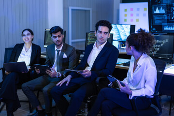 Diverse high performing team of data analysts and IT professionals collaborating in a control room. innovation, global business strategy, cybersecurity, and financial technology growth