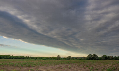Cloudy sky with a long line of clouds stretching across the sky