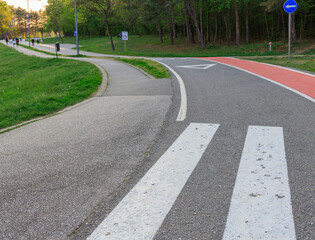 Obraz premium Road with a white line down the middle and a blue sign on the right
