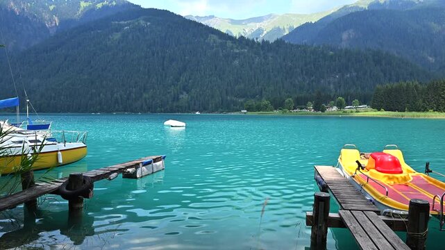 Clear Water at Weissensee Lake With Boats and Mountains