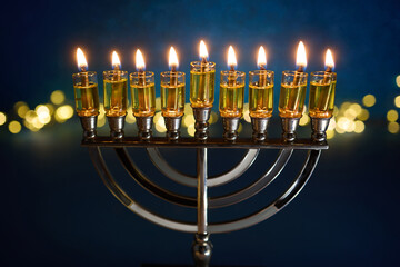 Hanukkah Glowing Menorah. A lit menorah against a vibrant blue