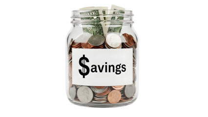 Glass jar filled with assorted coins and folded dollar bills clearly labeled savings for financial concepts