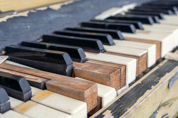 Close-up view of vintage piano keys, showcasing worn wooden textures and aged ivory, highlighting the beauty of musical craftsmanship and nostalgia in a classic instrument