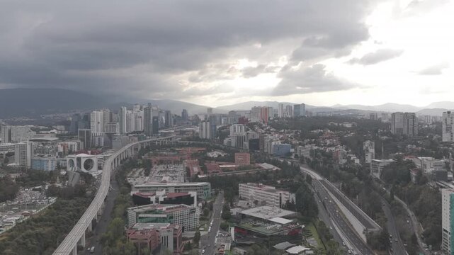 Aerial panoramic view of Santa Fe in Mexico City. Drone descending slowly while capturing the skyline against a dramatic sunset glow. shot on D-Log