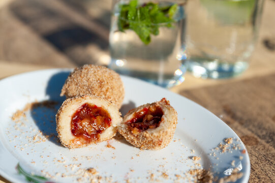 sweet plum dumplings with a glass of lemonade aside	