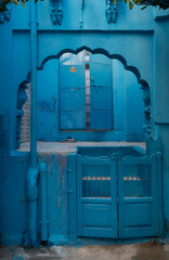 Blue painted wall. Jodhpur door in the blue city