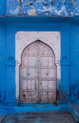Blue painted wall. Jodhpur door in the blue city