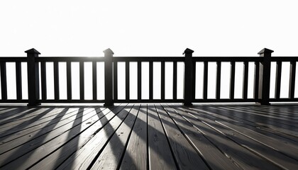 Fototapeta premium Dark wooden deck railing and floor create strong shadow lines against bright white sky. View from above deck towards horizon shows expanse. Outdoor space element.