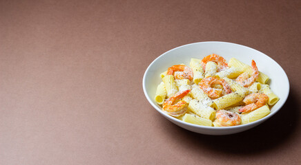 Pasta in a creamy sauce with shrimp and cheese. Seafood. Italian cuisine.