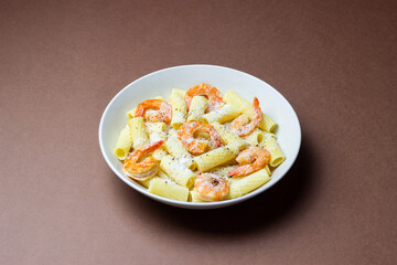 Pasta in a creamy sauce with shrimp and cheese. Seafood. Italian cuisine.