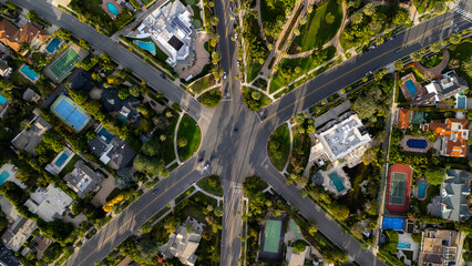 Aerial view of the meticulously planned intersection and manicured lawns, where roads converge amidst estates and verdant parks, Beverly Hills, California, United States.