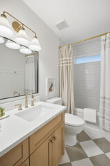 Bathroom with a white sink, toilet, and shower