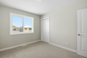 Bedroom with a white door and a window