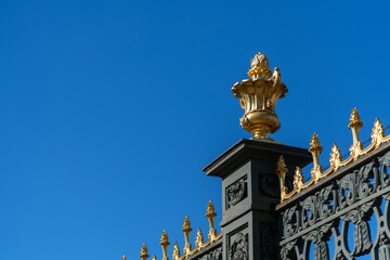 Golden gate detail in Saint Petersburg showcases ornate design against blue sky