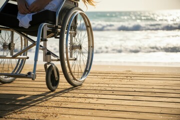 Sitting in a wheelchair on a wooden boardwalk by the ocean during sunset with waves in the background