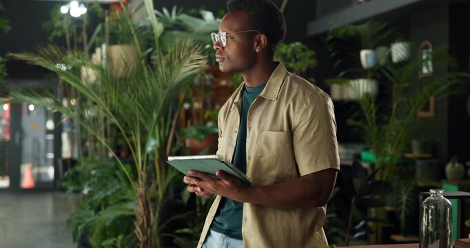 Man, botanist and thinking with tablet at shop, inventory management and contact supplier for stock. African person, tech and report with notes, app or check notification for deal at flower store