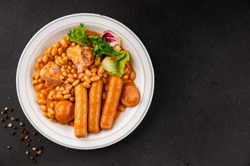 Casule meat with beans in sauce sausages, pork main course tasty snack fresh delicious gourmet food table background rustic food top view copy space