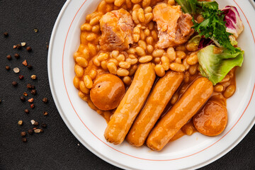 Casule meat with beans in sauce sausages, pork main course tasty snack fresh delicious gourmet food table background rustic food top view copy space