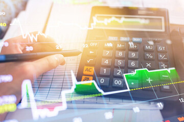 Financial analysis with calculator and stock market graph overlay