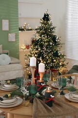 Festive table setting with Christmas decor indoors, closeup