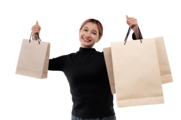 Happy young woman holding shopping bags on transparent background.