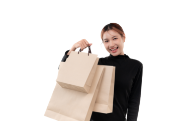 Happy young woman holding shopping bags on transparent background.