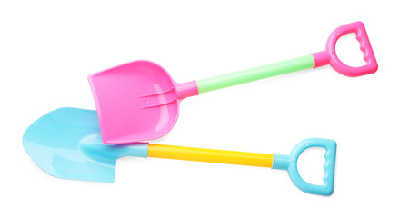 Bright plastic shovels isolated on white, top view. Children's beach toys
