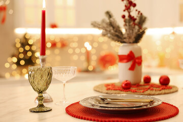 Christmas decor and tableware on light table in kitchen, closeup. Interior design
