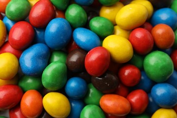 Many delicious colorful candies as background, closeup