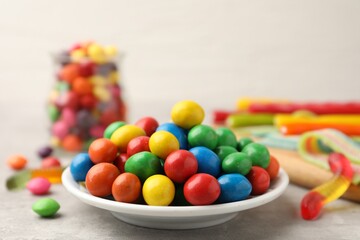 Delicious colorful candies on light table, closeup. Space for text