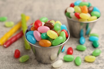 Delicious colorful candies on grey table, closeup