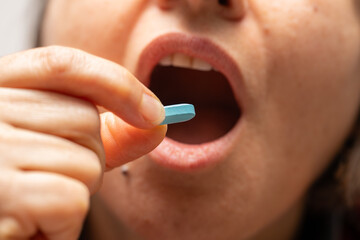 A woman who takes medication when she is sick. Excessive medication use negatively affects health.