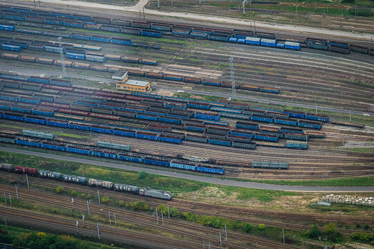 Aerial view of a sprawling railway yard with numerous trains and tracks creates a complex network of steel and movement, Warsaw, Poland.