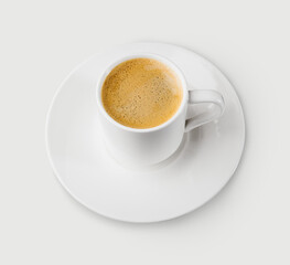 a small cup of coffee with foam on a white saucer, close-up on a white background