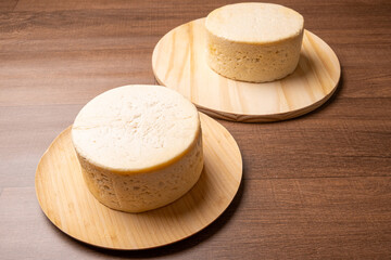 Semi-cured cheese, a wonderful semi-cured cheese from Minas Gerais on a rustic surface, selective focus.