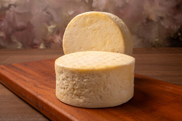 Semi-cured cheese, a wonderful semi-cured cheese from Minas Gerais on a rustic surface, selective focus.