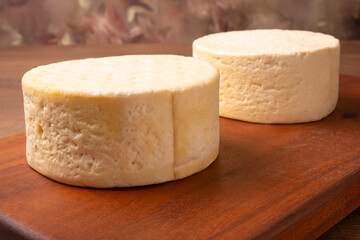 Semi-cured cheese, a wonderful semi-cured cheese from Minas Gerais on a rustic surface, selective focus.