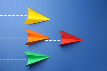 Paper planes with dotted lines as air route track on blue background © New Africa