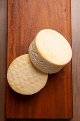 Semi-cured cheese, a wonderful semi-cured cheese from Minas Gerais on a rustic surface, selective focus.