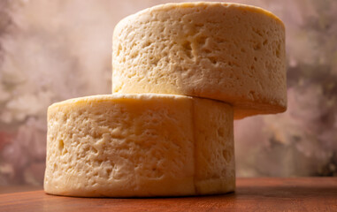 Semi-cured cheese, a wonderful semi-cured cheese from Minas Gerais on a rustic surface, selective focus.
