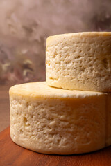 Semi-cured cheese, a wonderful semi-cured cheese from Minas Gerais on a rustic surface, selective focus.