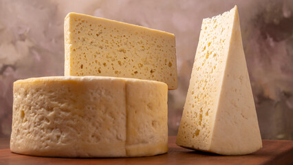 Semi-cured cheese, a wonderful semi-cured cheese from Minas Gerais on a rustic surface, selective focus.