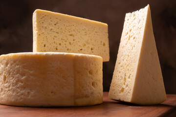 Semi-cured cheese, a wonderful semi-cured cheese from Minas Gerais on a rustic surface, selective focus.