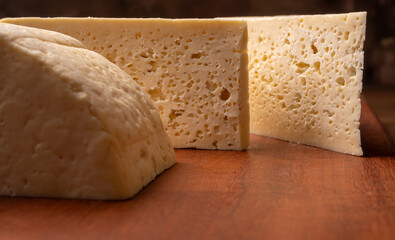 Semi-cured cheese, a wonderful semi-cured cheese from Minas Gerais on a rustic surface, selective focus.