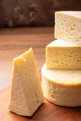 Semi-cured cheese, a wonderful semi-cured cheese from Minas Gerais on a rustic surface, selective focus.